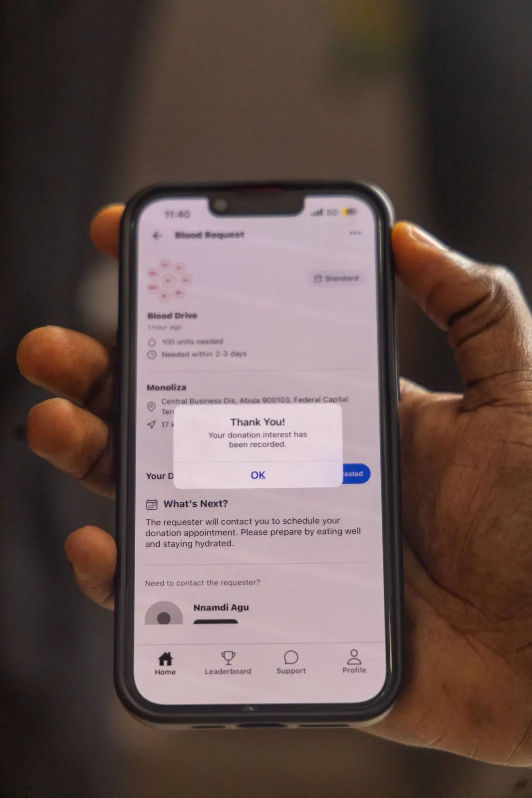 The OnePint Plus app showing a confirmed blood-donation request on a phone