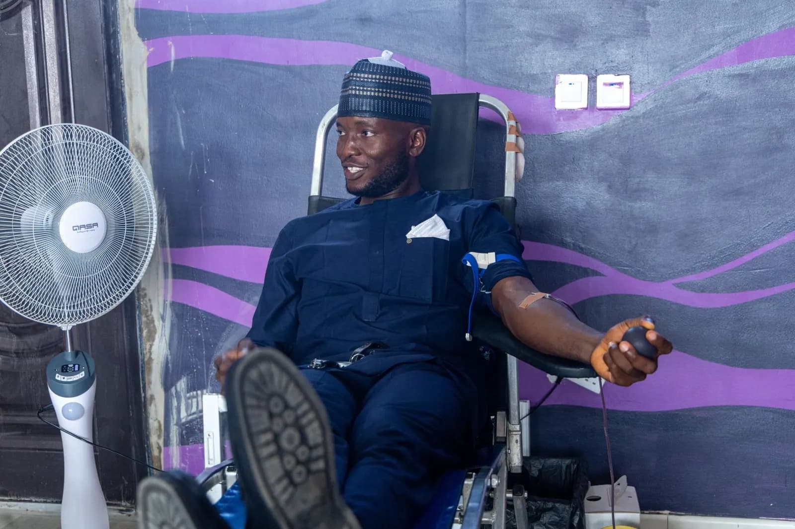 A relaxed donor giving blood during a OnePint Plus community drive